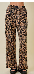 Zebra print pants worn by a person on a beige background
